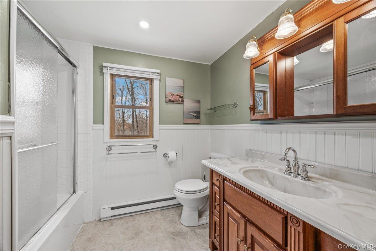 155 Mill Street Wallkill, NY 12589 - Photo 9 of 26 a bathroom with a sink a toilet and a large mirror