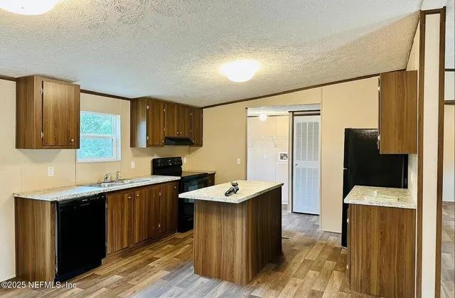 a kitchen with a refrigerator and a sink