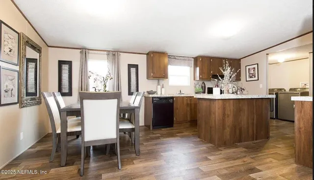 a kitchen with stainless steel appliances granite countertop a sink refrigerator and microwave