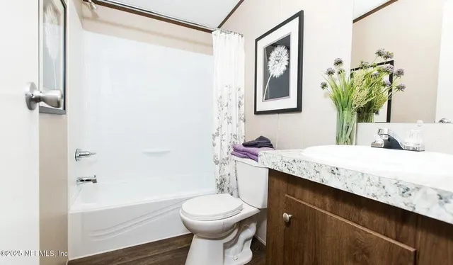 a bedroom with a bed and lamp on the dresser