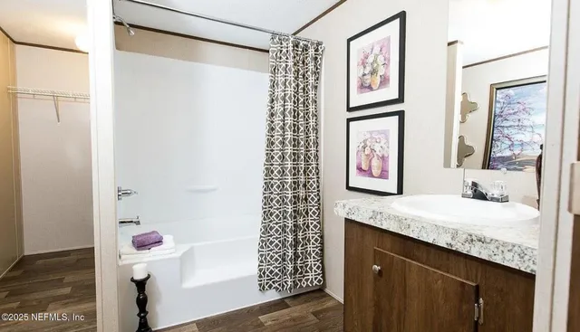 a bathroom with a tub a sink and a shower