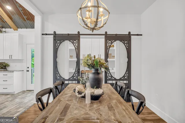 a view of a dining room with furniture and wooden floor