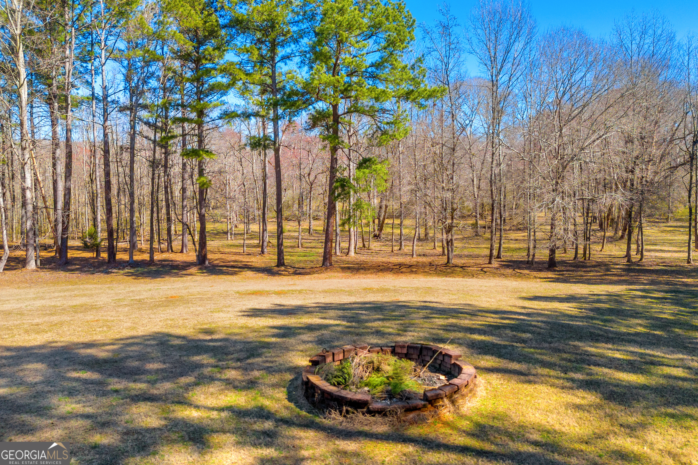 599 Double Branch Road Danielsville, GA 30633 - Photo 117 of 158 a view of a swimming pool with an outdoor space and seating area