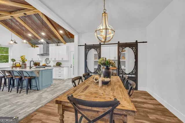 a dining room with furniture and wooden floor