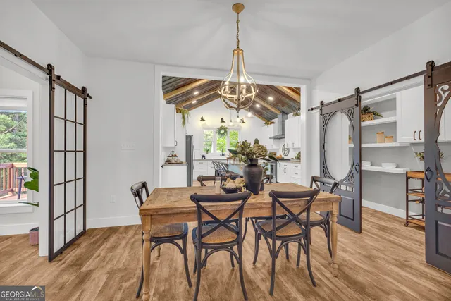 a kitchen with stainless steel appliances granite countertop a stove a sink dishwasher and cabinets with wooden floor