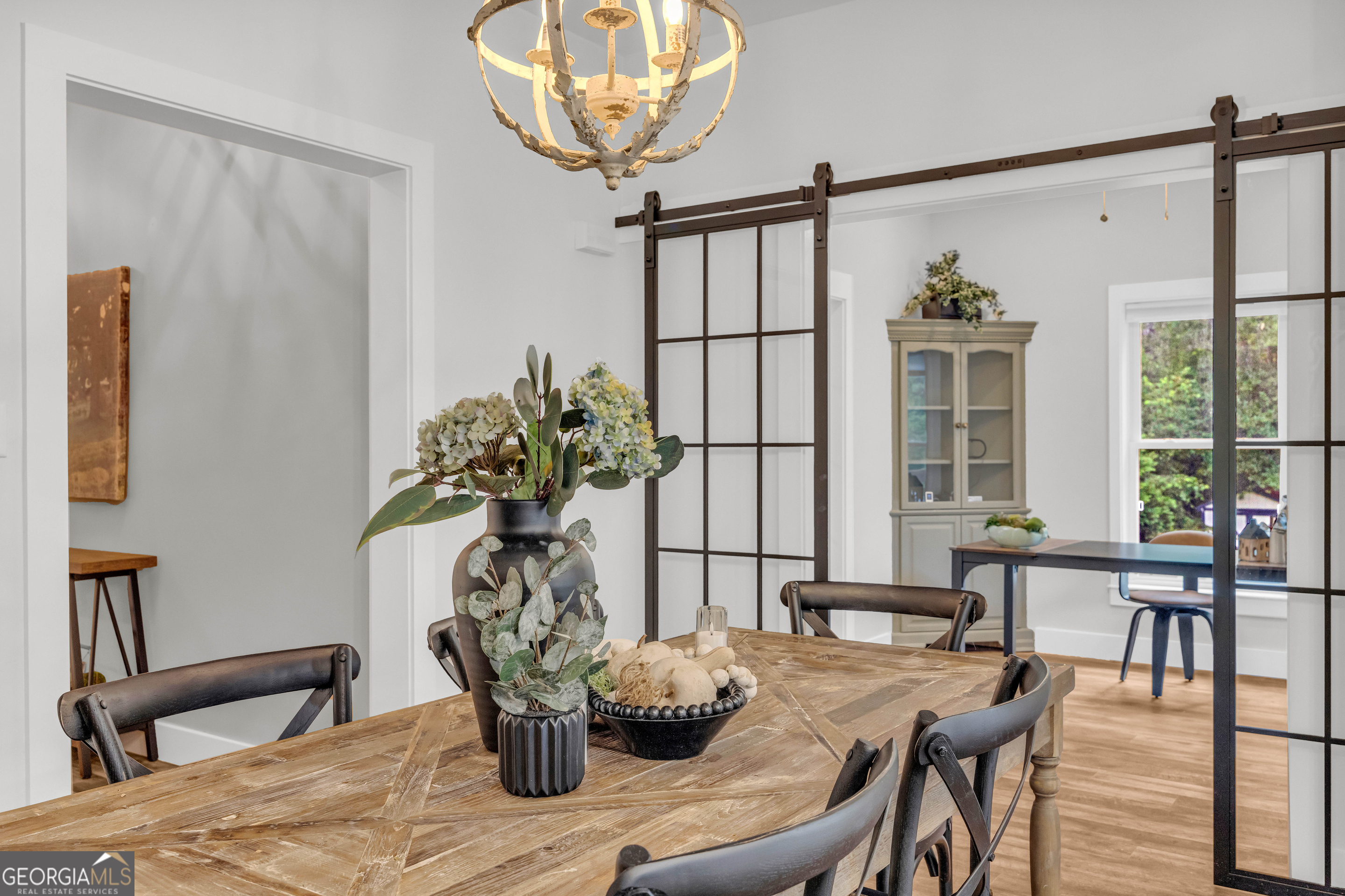 599 Double Branch Road Danielsville, GA 30633 - Photo 152 of 158 a dining room with furniture potted plants and wooden floor