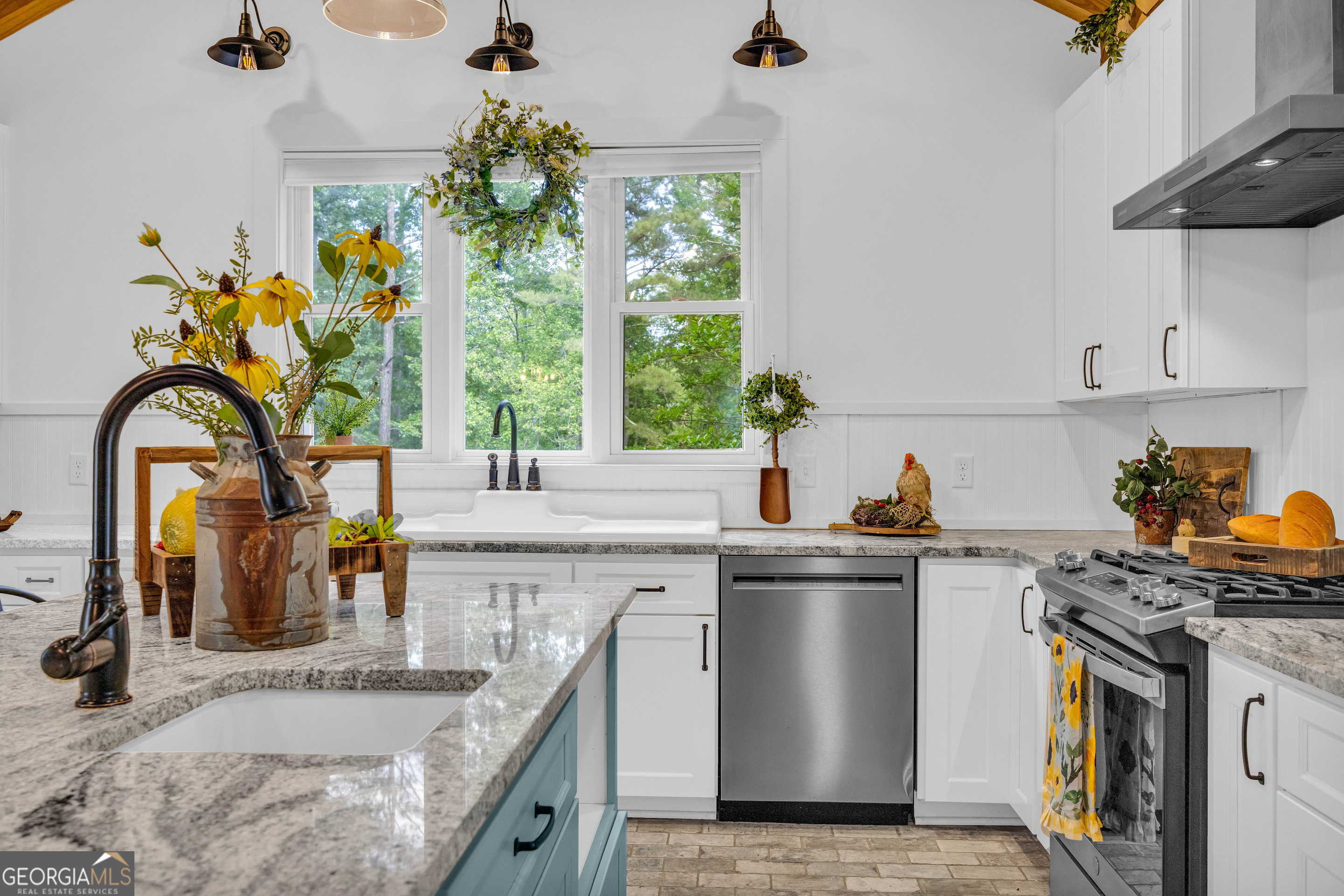 599 Double Branch Road Danielsville, GA 30633 - Photo 153 of 158 a kitchen with stainless steel appliances granite countertop a sink a stove and a wooden floor