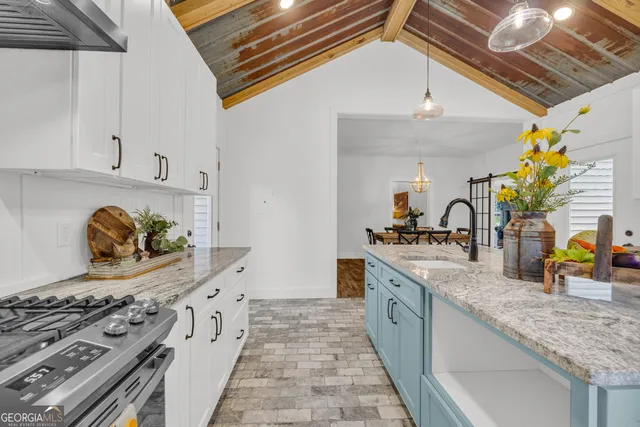 a view of a room with wooden floor and ceiling fan