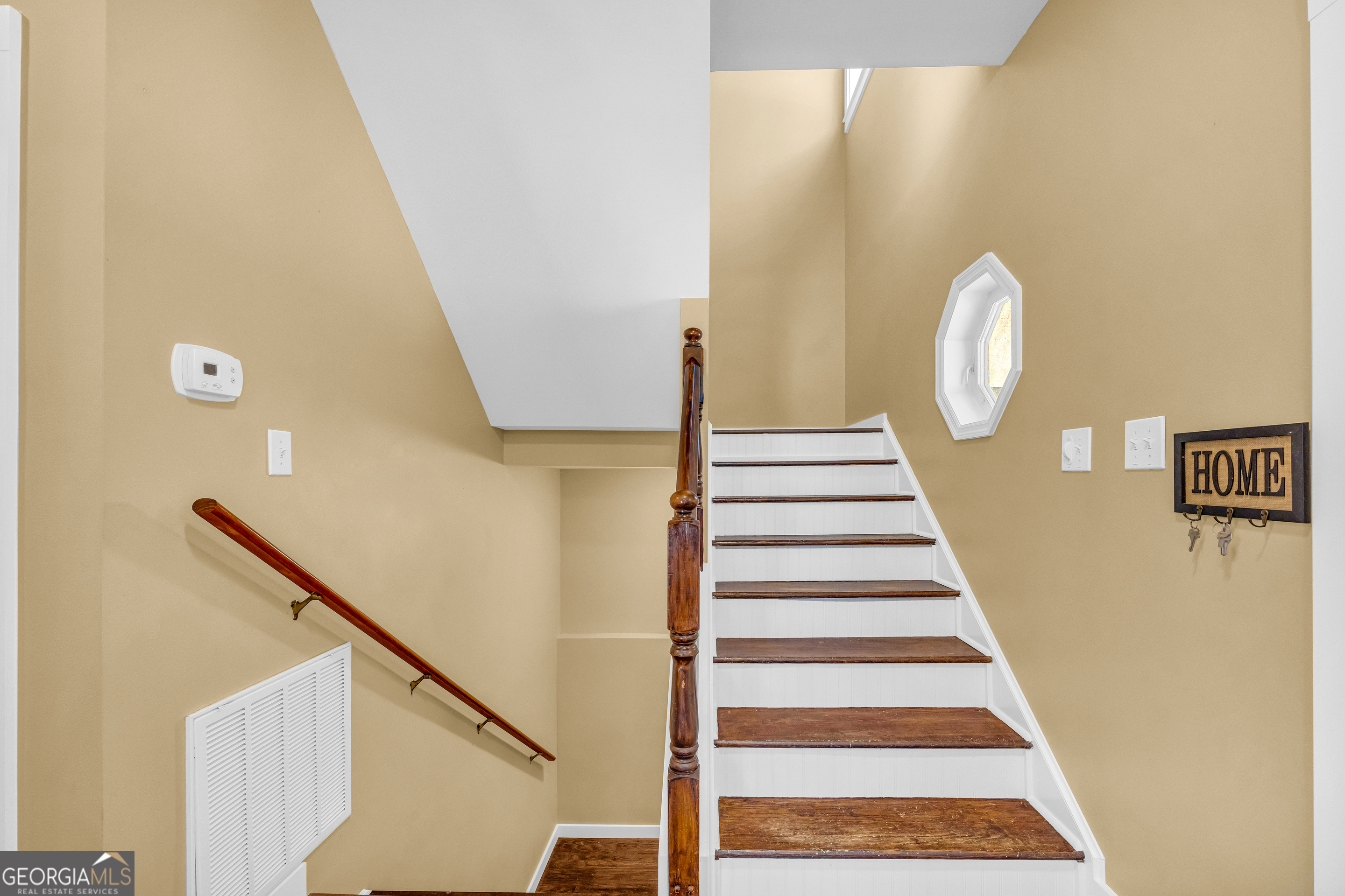 599 Double Branch Road Danielsville, GA 30633 - Photo 36 of 158 a view of a staircase with wooden floor and white walls