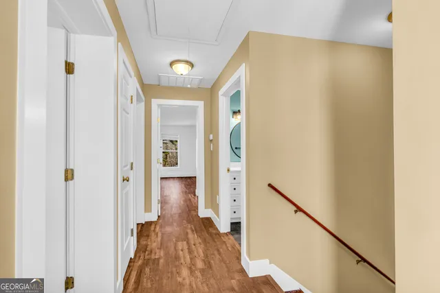 a front view of a house with yard and trees