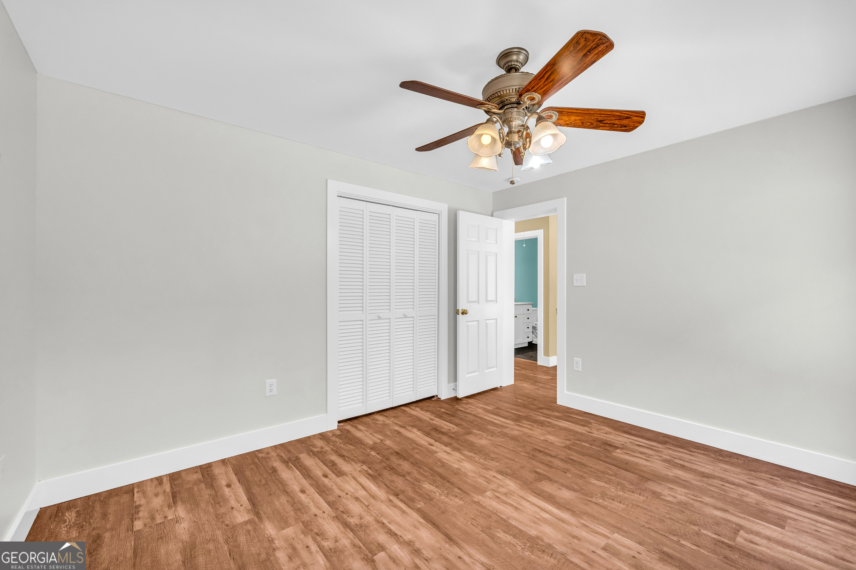 599 Double Branch Road Danielsville, GA 30633 - Photo 39 of 158 a view of a room with wooden floor and ceiling fan