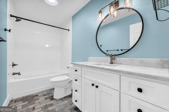 a kitchen with stainless steel appliances granite countertop a sink a stove and a wooden floors