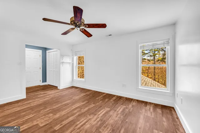 a kitchen with stainless steel appliances granite countertop a sink a stove and a wooden floor