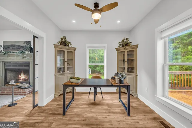 a dining room with furniture a chandelier and wooden floor