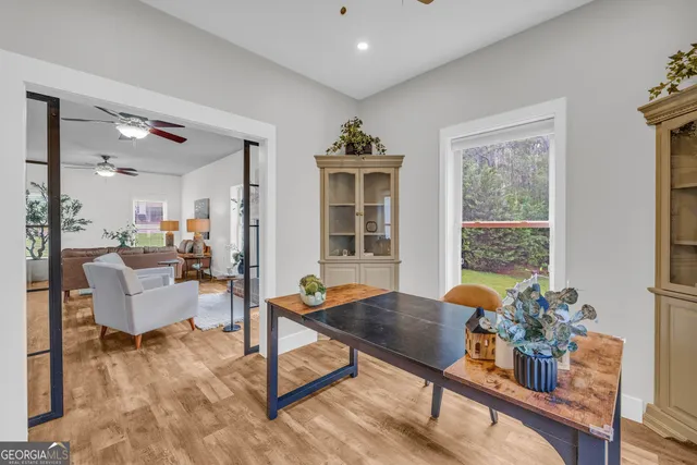 a view of a dining room with furniture and chandelier