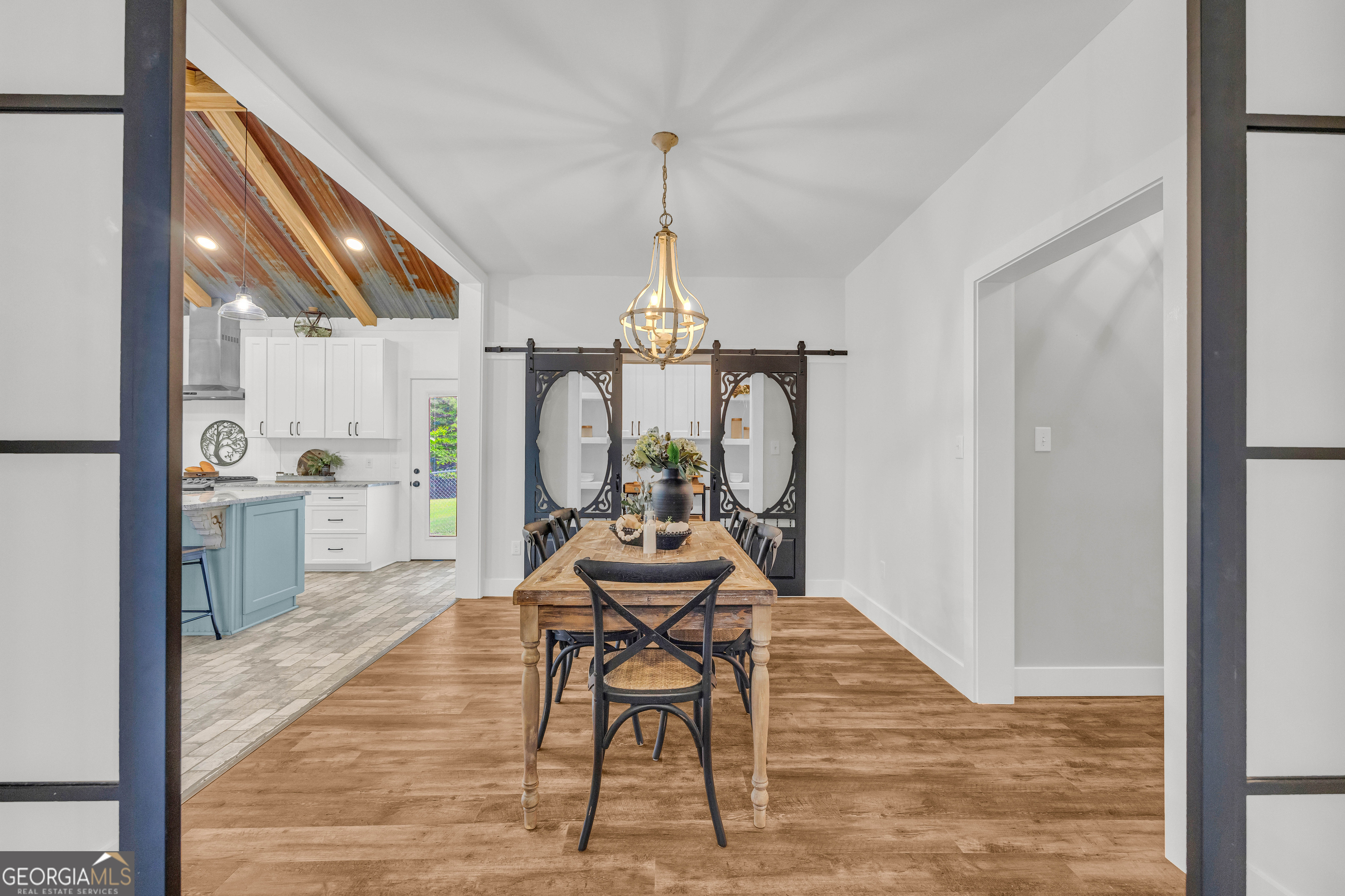 599 Double Branch Road Danielsville, GA 30633 - Photo 10 of 158 a dining room with furniture a chandelier and wooden floor