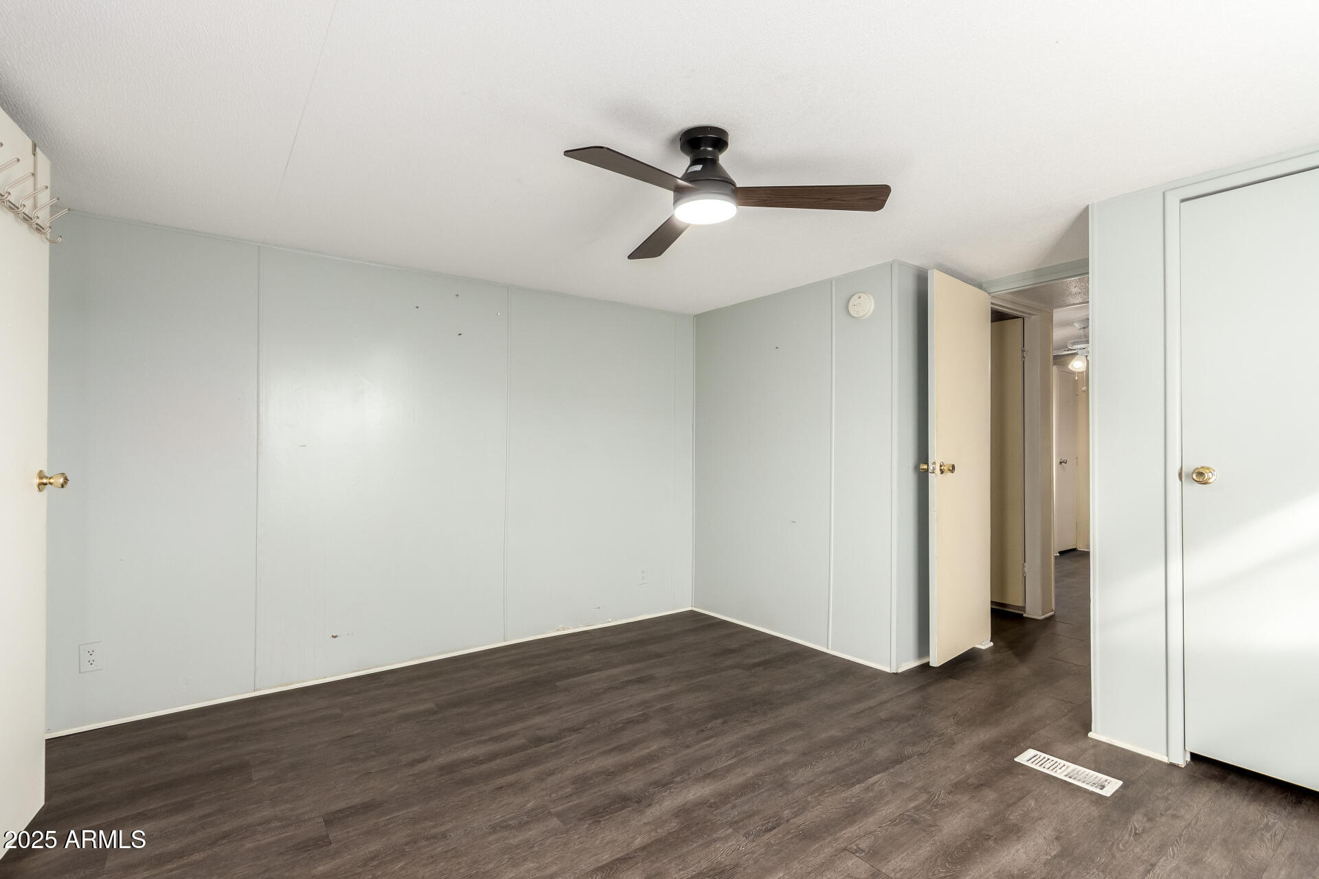 10401 North Cave Creek Road, Unit 93 Phoenix, AZ 85020 - Photo 13 of 28 a view of a room with wooden floor and a ceiling fan