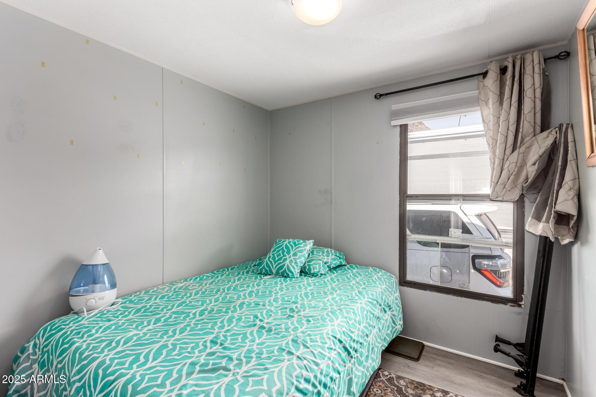 10401 North Cave Creek Road, Unit 93 Phoenix, AZ 85020 - Photo 20 of 28 a bedroom with a bed and a window