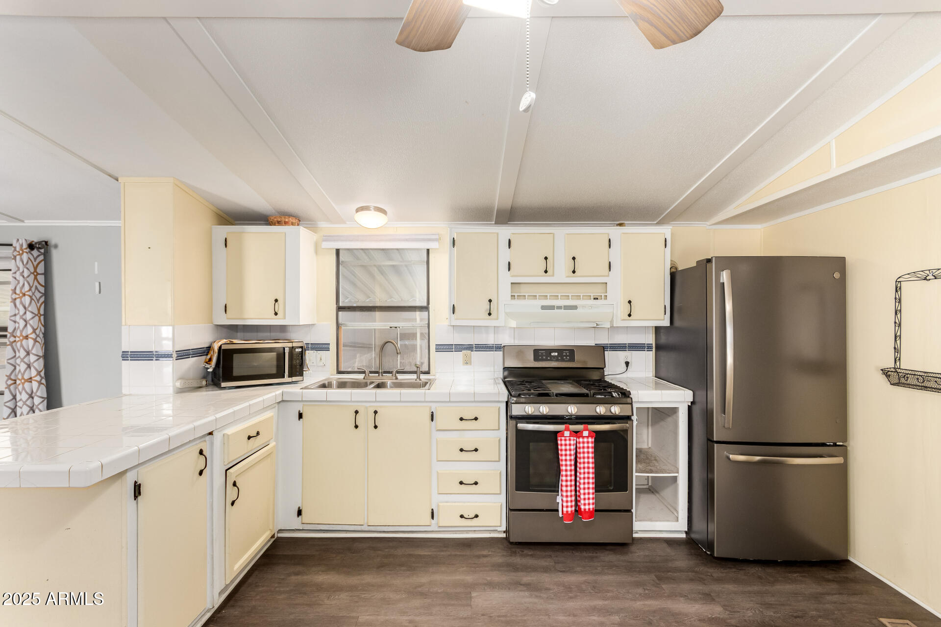 10401 North Cave Creek Road, Unit 93 Phoenix, AZ 85020 - Photo 7 of 28 a kitchen with stainless steel appliances a refrigerator sink and cabinets