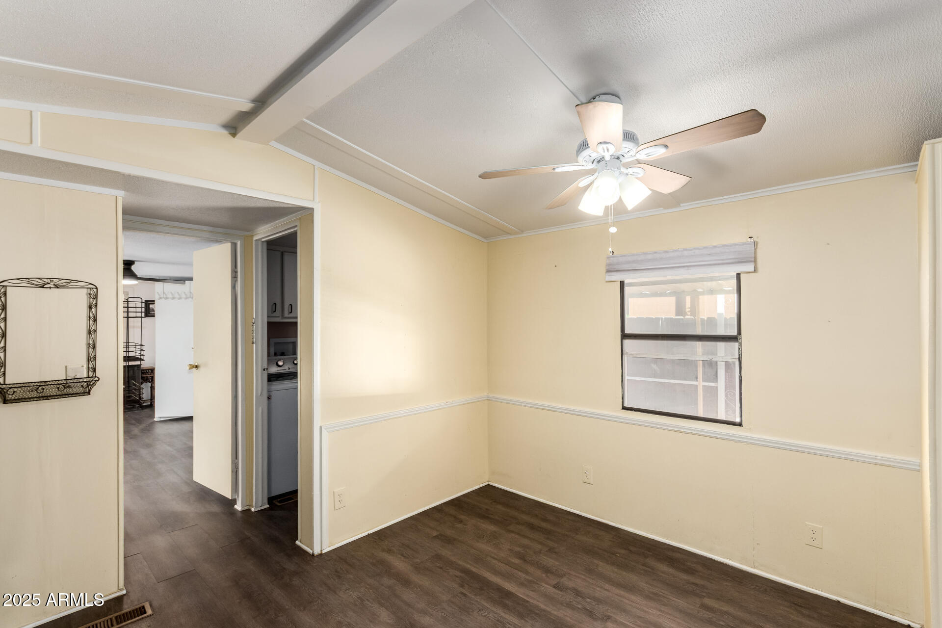 10401 North Cave Creek Road, Unit 93 Phoenix, AZ 85020 - Photo 8 of 28 a view of an empty room with a window and wooden floor