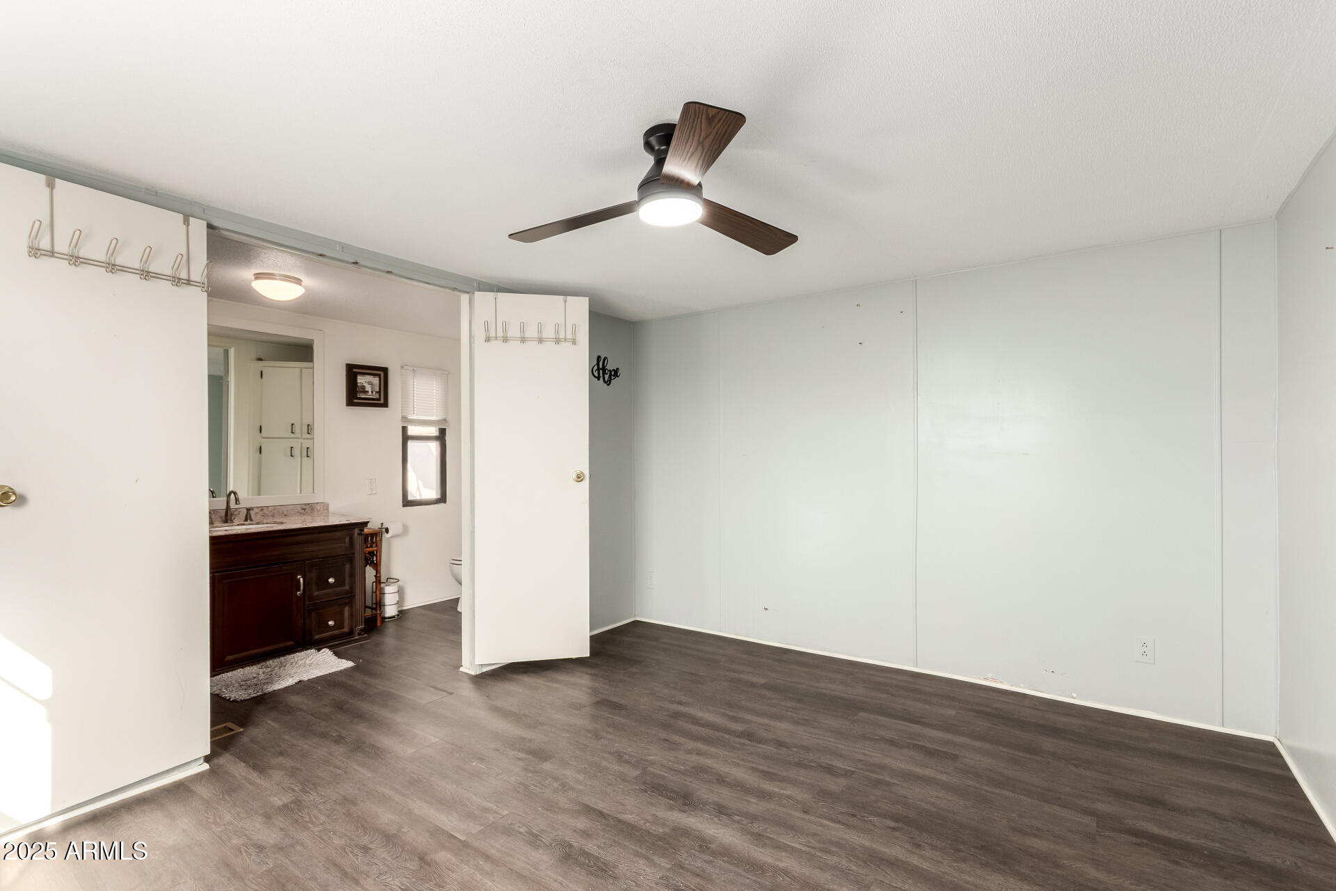 10401 North Cave Creek Road, Unit 93 Phoenix, AZ 85020 - Photo 10 of 28 a view of an empty room and wooden floor