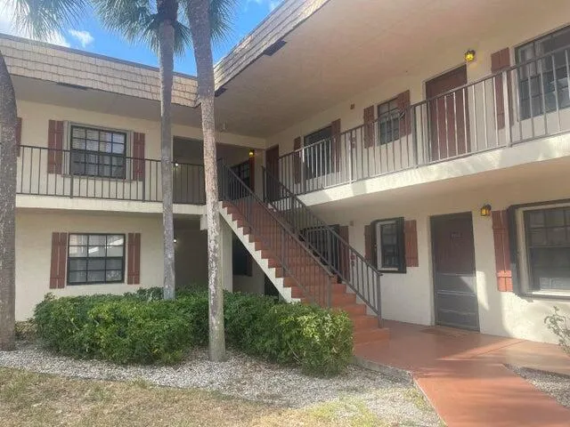 a front view of a house with plants