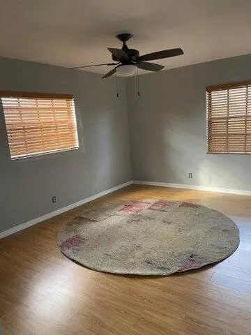 an view of a room with wooden floor and a window