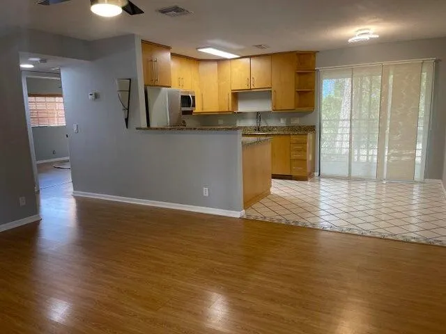 a kitchen with stainless steel appliances granite countertop a sink refrigerator and cabinets