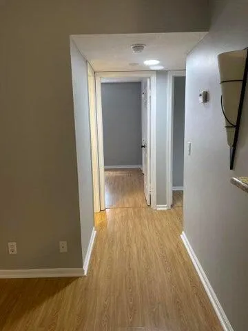 a view of a room with wooden floor and bathroom