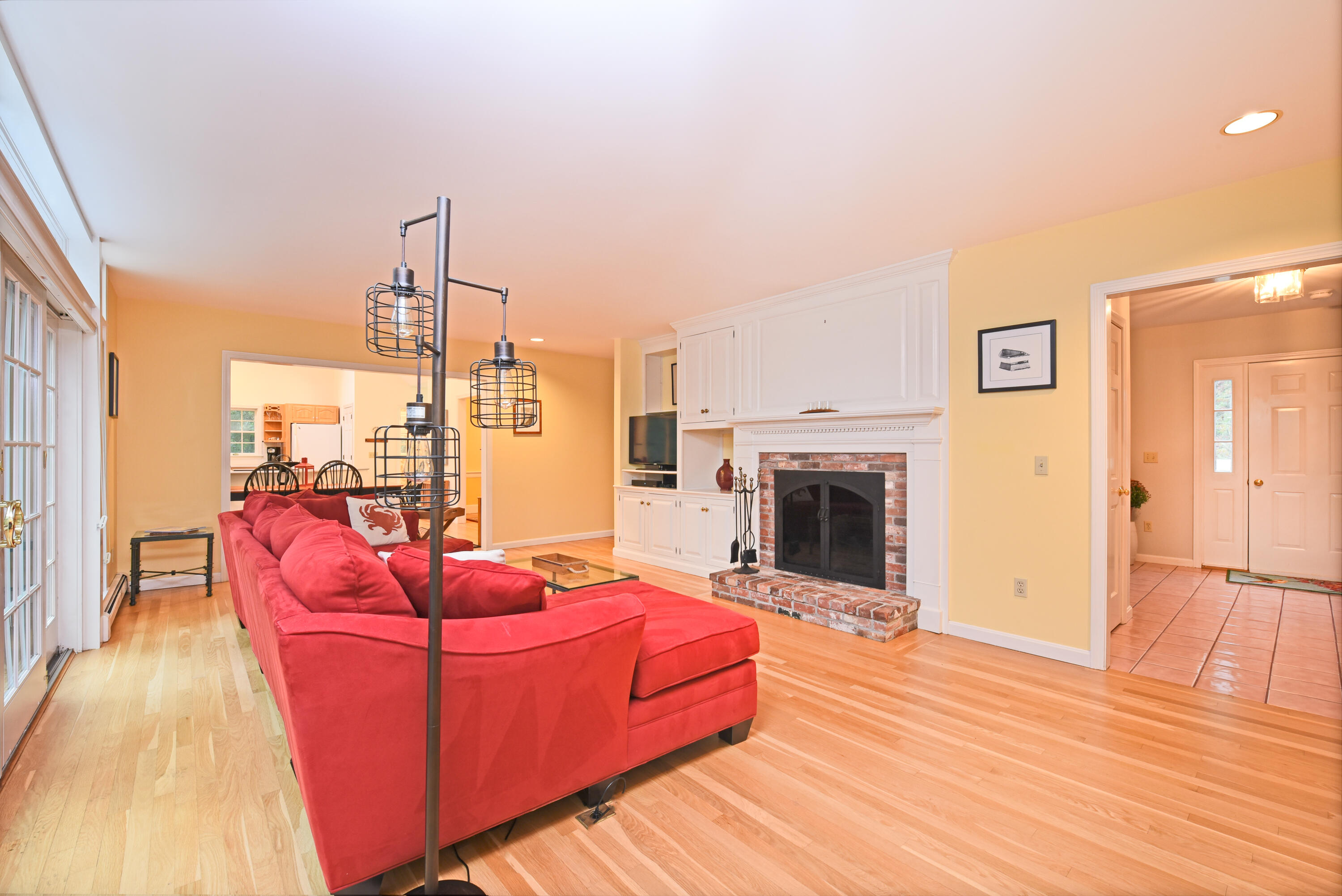 7 Captain Scott Road Harwich, MA 02645 - Photo 17 of 41 a living room with furniture a fireplace and wooden floor