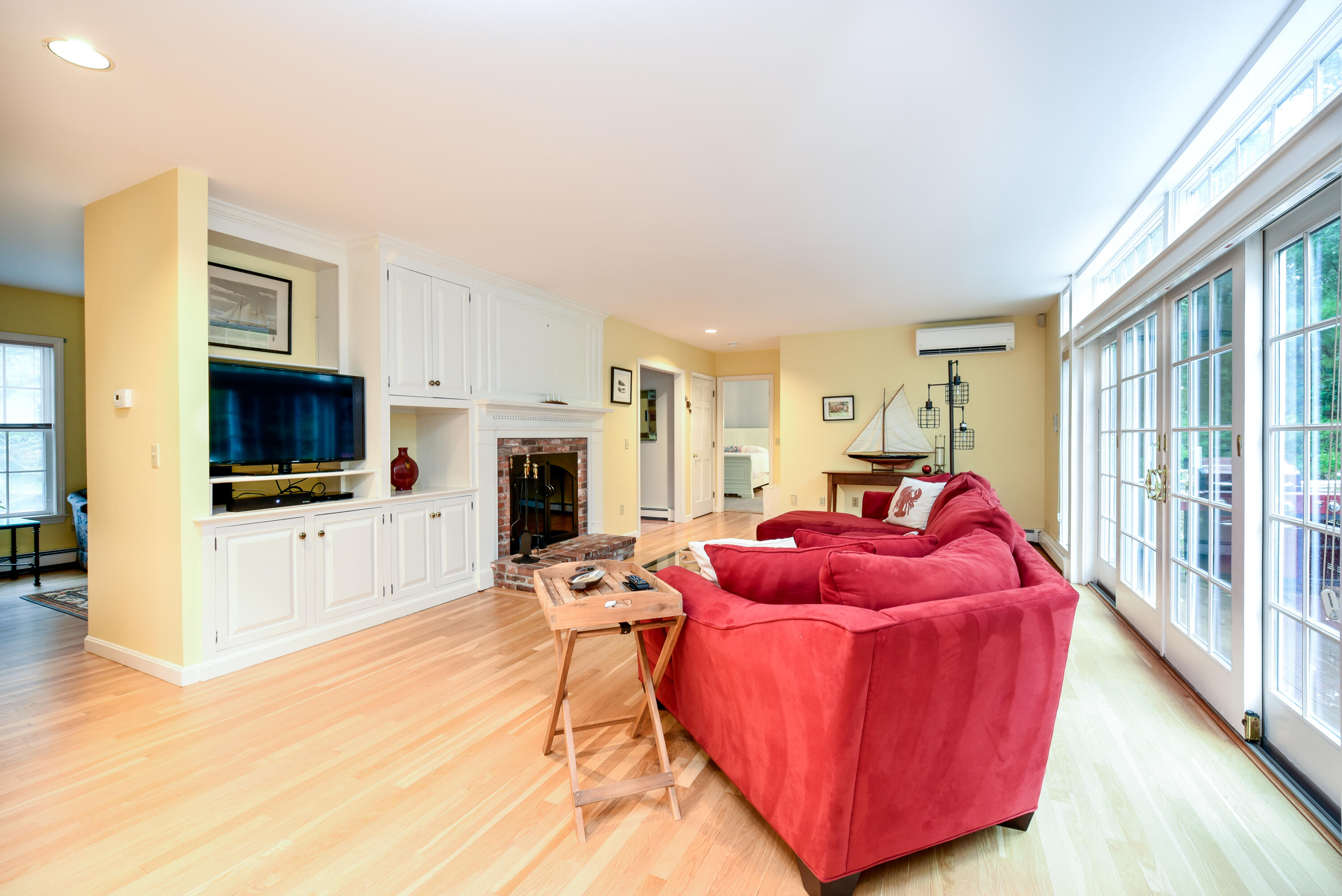 7 Captain Scott Road Harwich, MA 02645 - Photo 19 of 41 a living room with furniture a flat screen tv and a fireplace