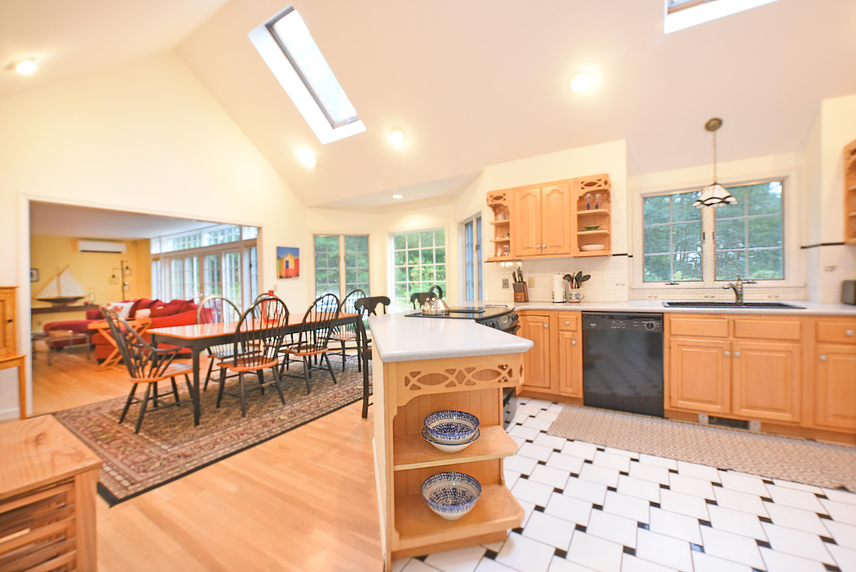 7 Captain Scott Road Harwich, MA 02645 - Photo 24 of 41 a open kitchen with stainless steel appliances granite countertop a stove a sink a dining table and chair with the view of living room