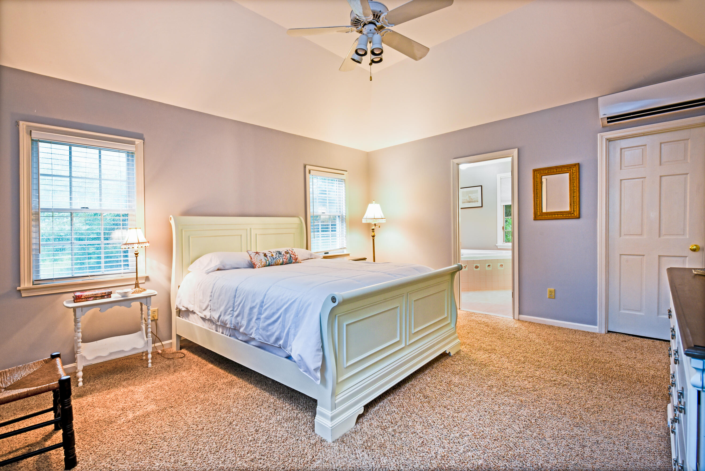 7 Captain Scott Road Harwich, MA 02645 - Photo 28 of 41 a bedroom with a bed and a chandelier