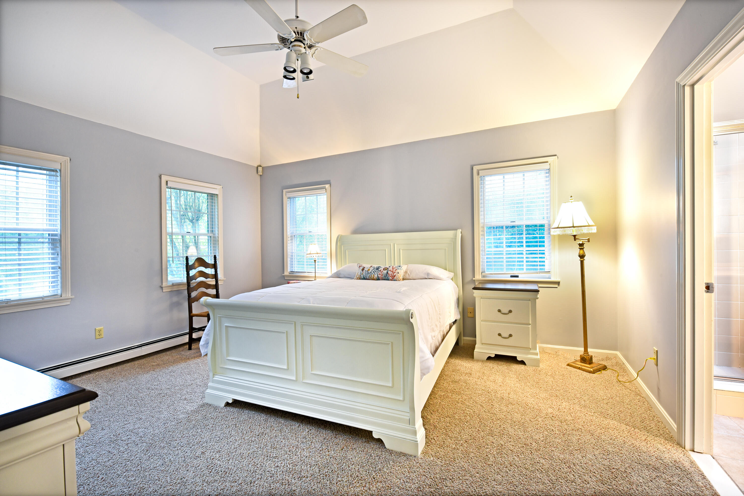 7 Captain Scott Road Harwich, MA 02645 - Photo 29 of 41 a bedroom with a bed and a chandelier