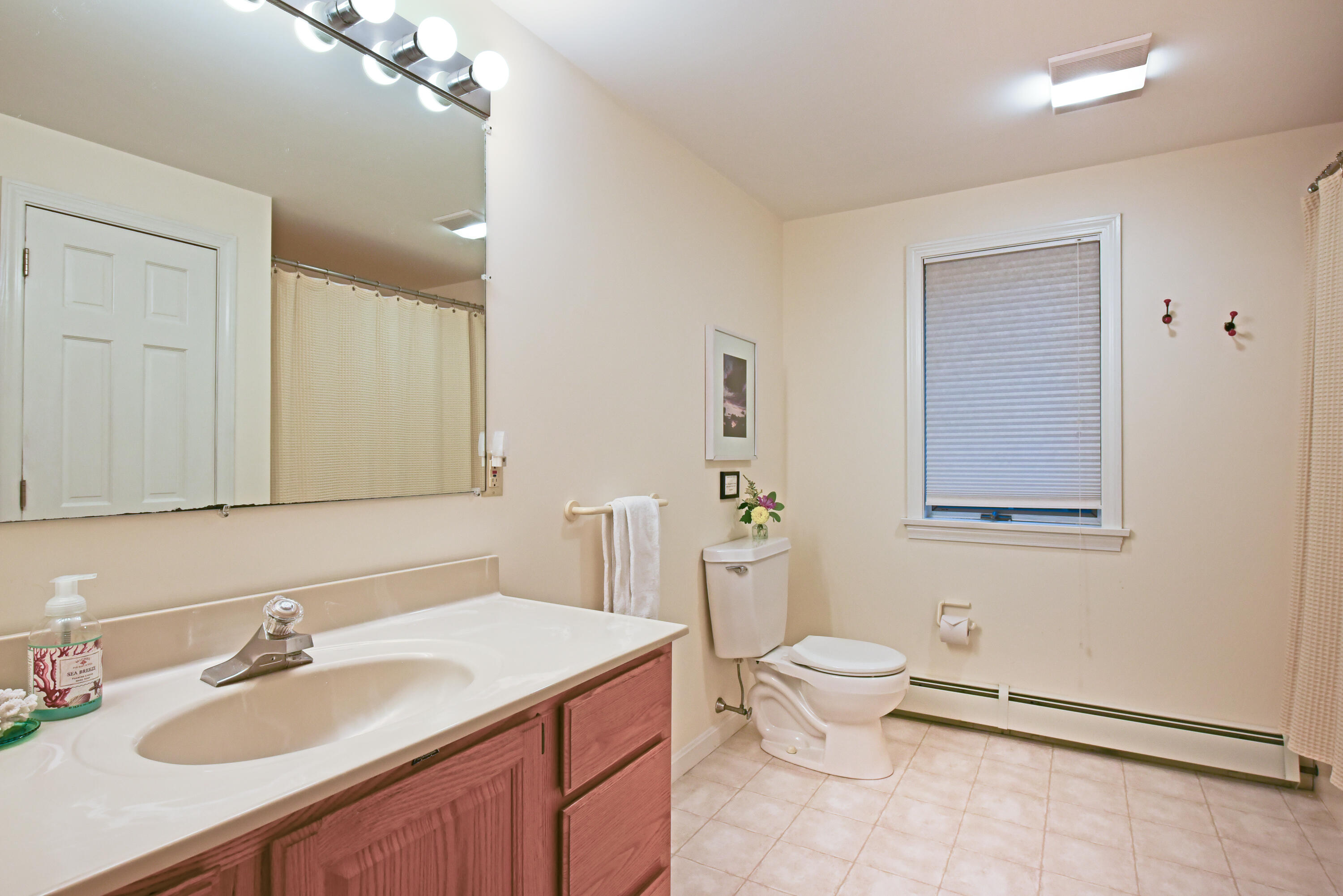7 Captain Scott Road Harwich, MA 02645 - Photo 33 of 41 a bathroom with a granite countertop sink a toilet and a mirror