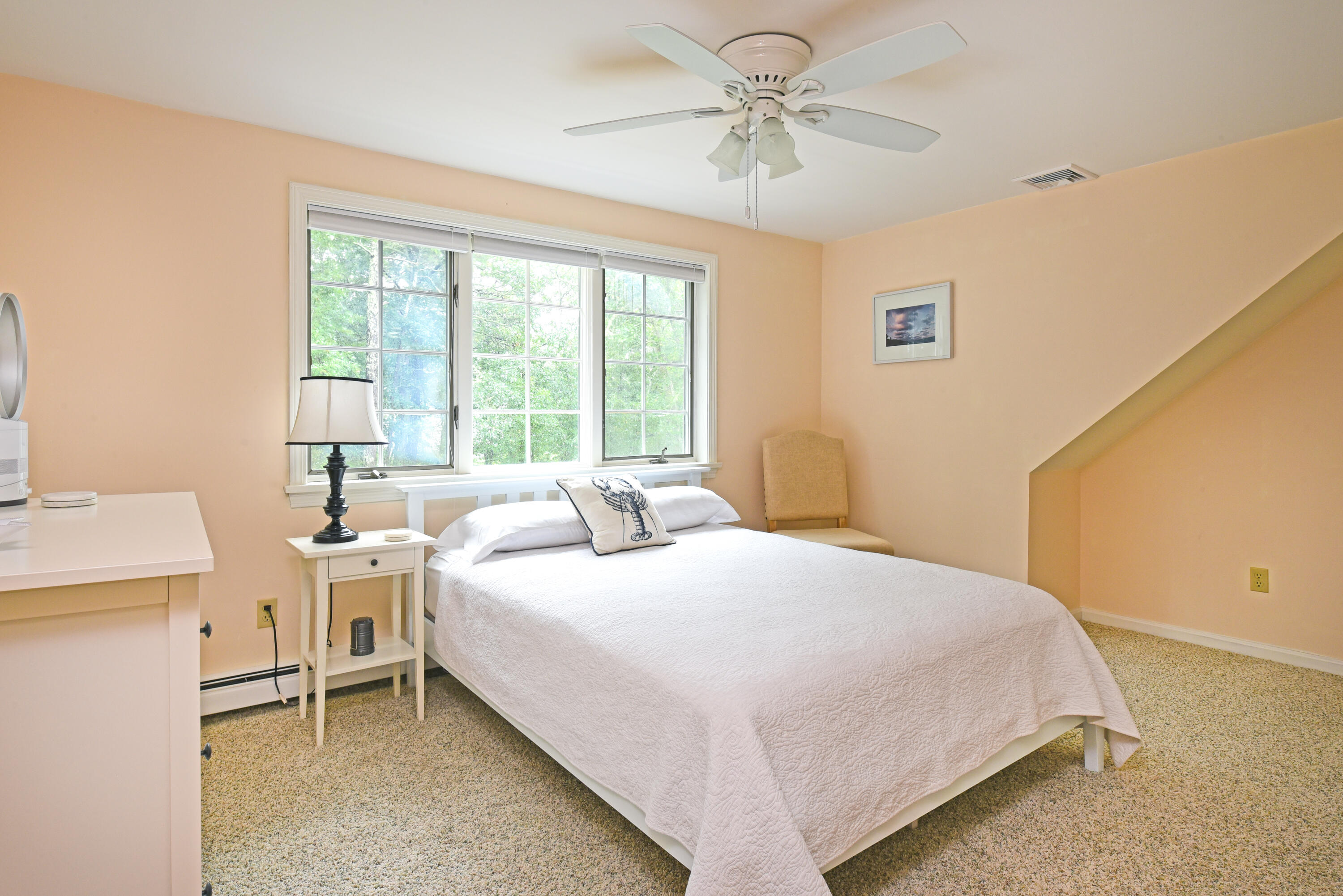 7 Captain Scott Road Harwich, MA 02645 - Photo 34 of 41 a bedroom with a bed and a chandelier