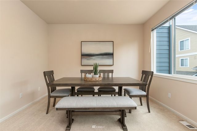 a view of a dining room with furniture and window