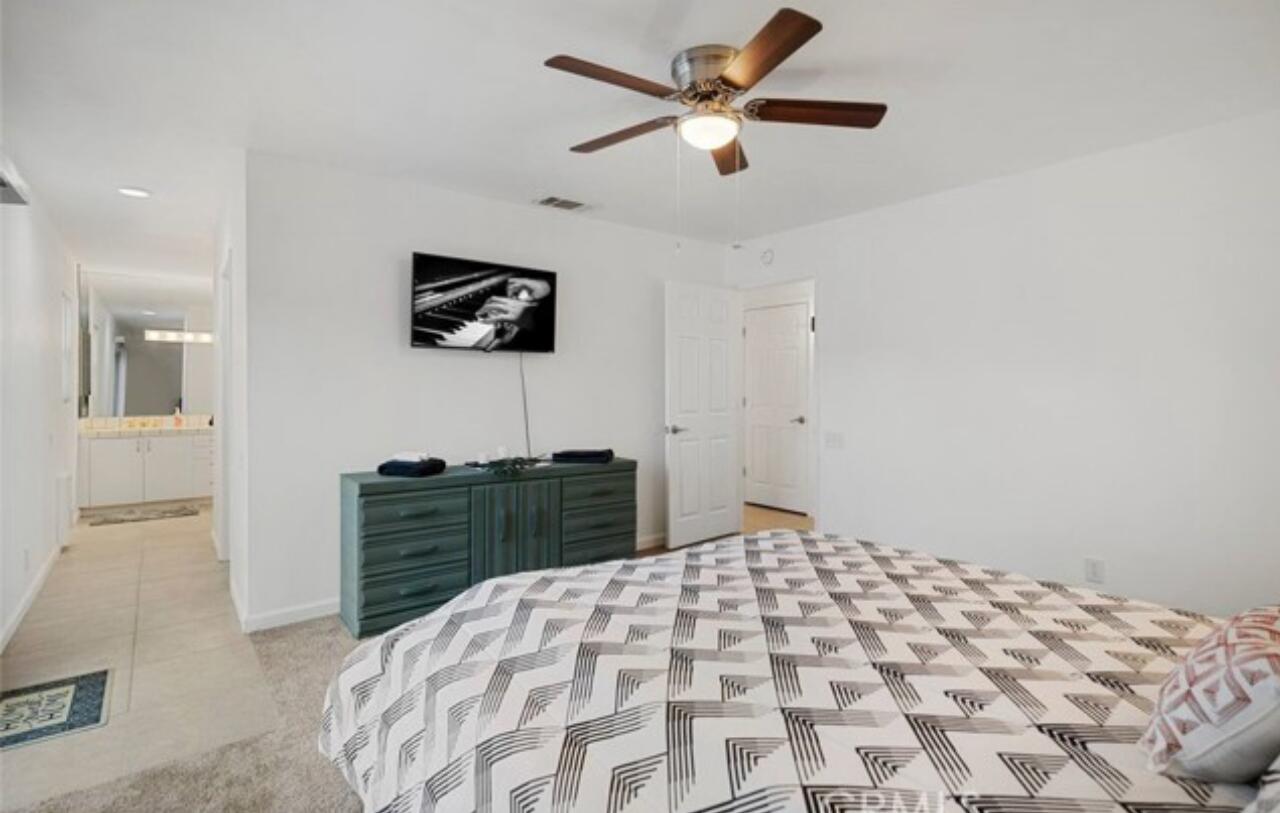 8564 Taft Court Yucca Valley, CA 92284 - Photo 13 of 25 a bedroom with a bed and a window