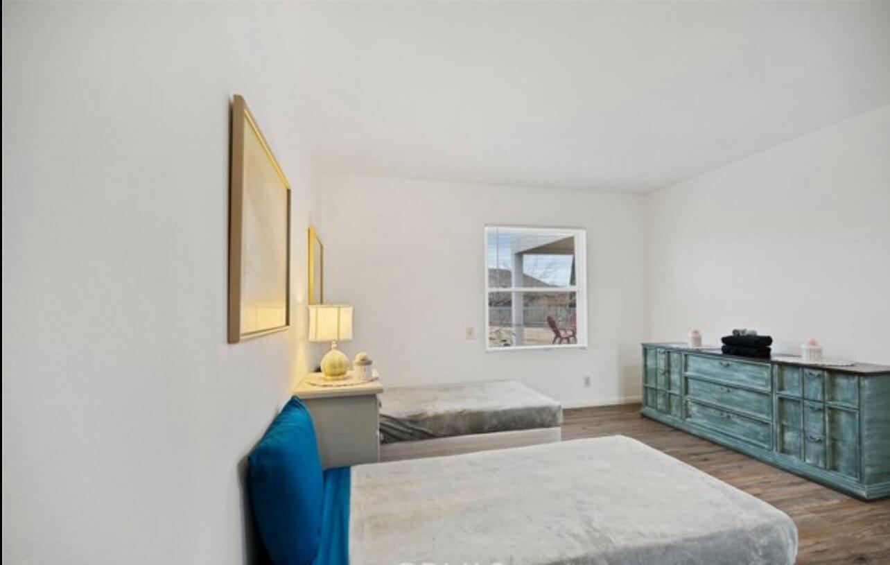 8564 Taft Court Yucca Valley, CA 92284 - Photo 18 of 25 a bedroom with a bed and a window