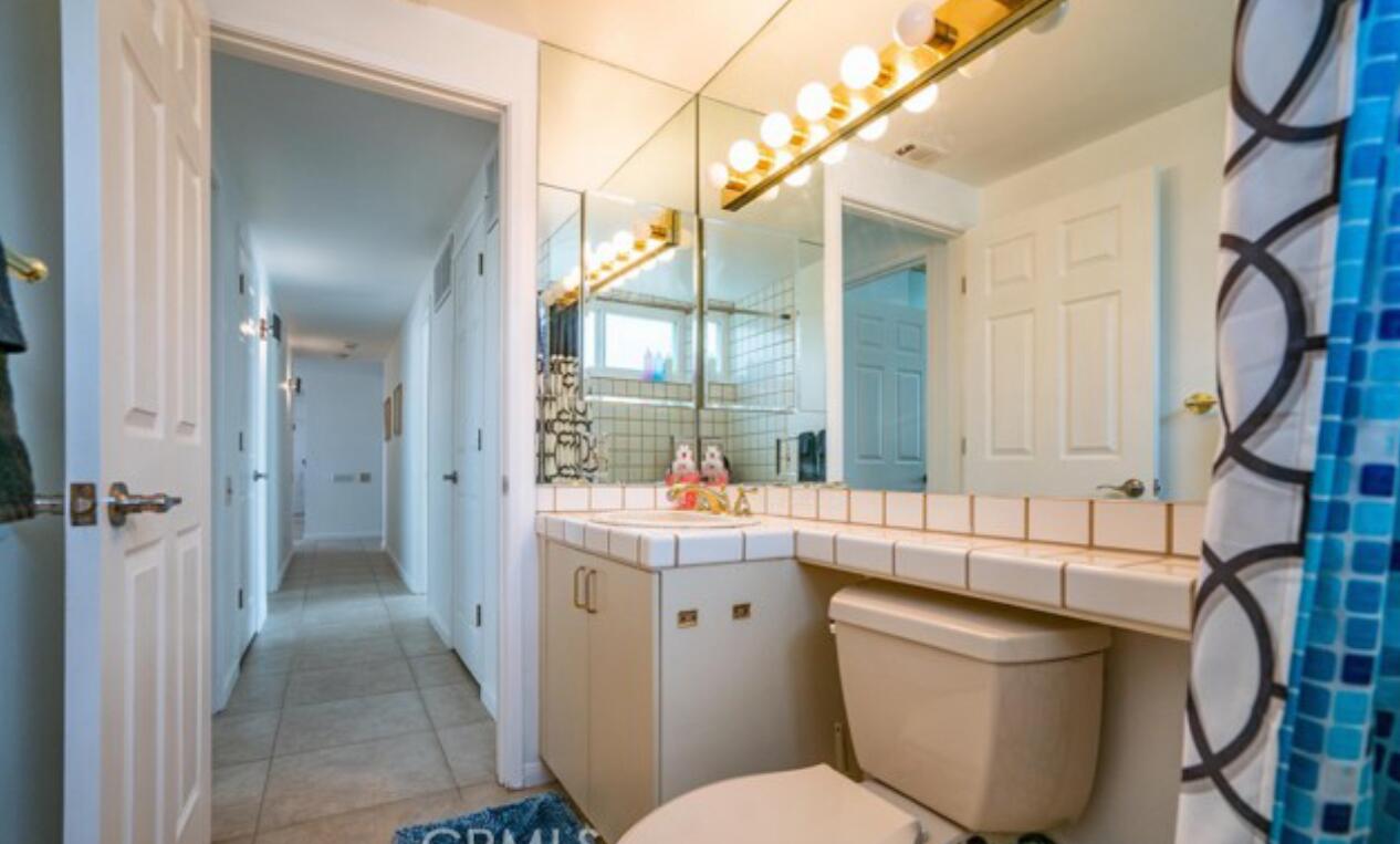 8564 Taft Court Yucca Valley, CA 92284 - Photo 21 of 25 a bathroom with a toilet sink and mirror