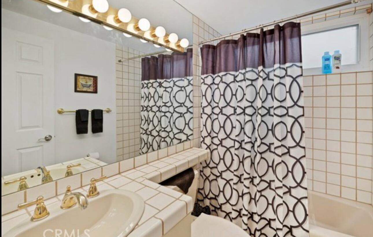 8564 Taft Court Yucca Valley, CA 92284 - Photo 23 of 25 a bathroom with a sink and a mirror