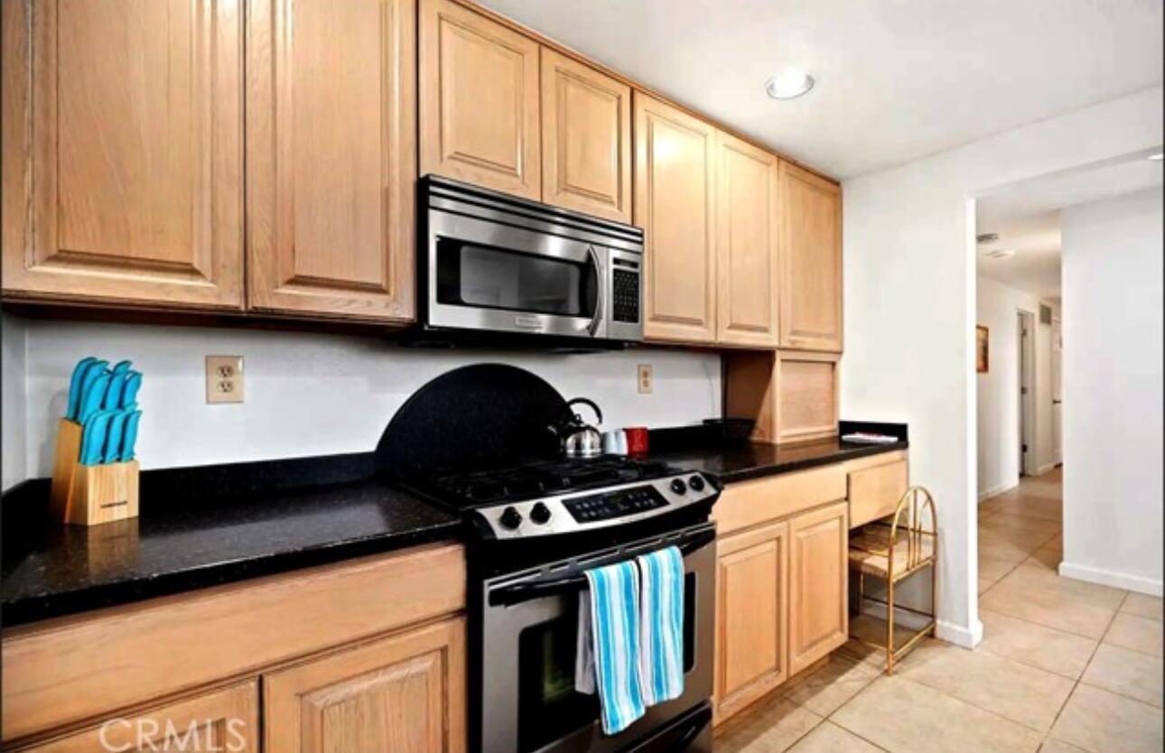 8564 Taft Court Yucca Valley, CA 92284 - Photo 4 of 25 a kitchen with stainless steel appliances granite countertop a stove and a microwave
