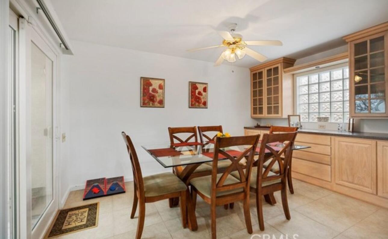 8564 Taft Court Yucca Valley, CA 92284 - Photo 6 of 25 a view of a dining room with furniture a chandelier and a window