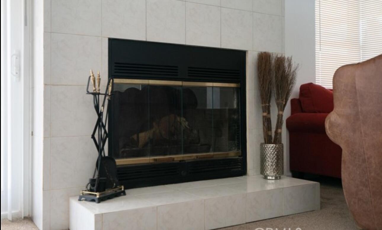 8564 Taft Court Yucca Valley, CA 92284 - Photo 10 of 25 a living room with a fireplace furniture and a window