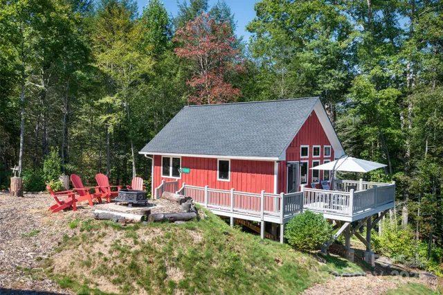 an aerial view of a house with swimming pool and deck
