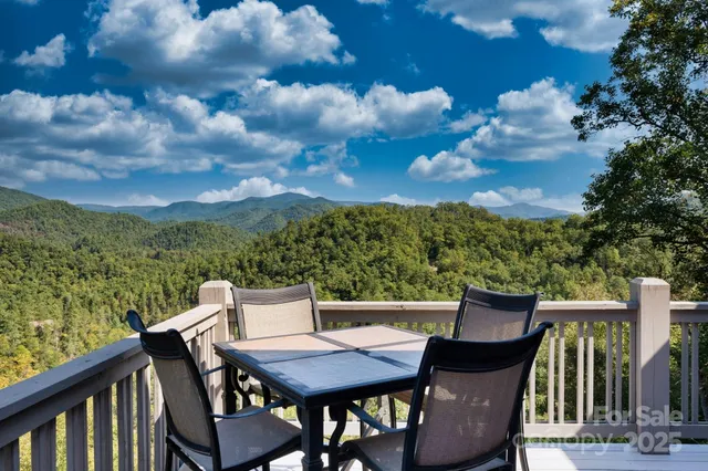 a view of a chairs and table in the balcony