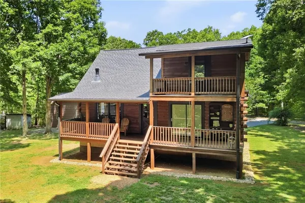 a view of a house with a backyard and a deck