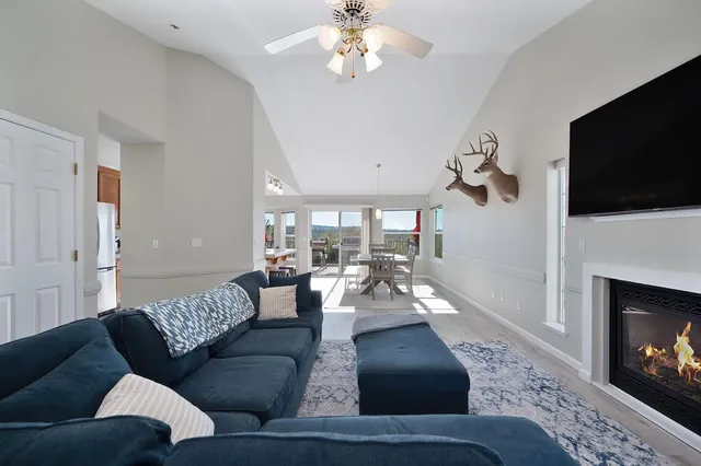 a living room with furniture a flat screen tv and a fireplace