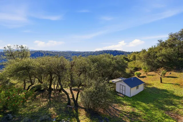 a backyard of a house with a table and chairs