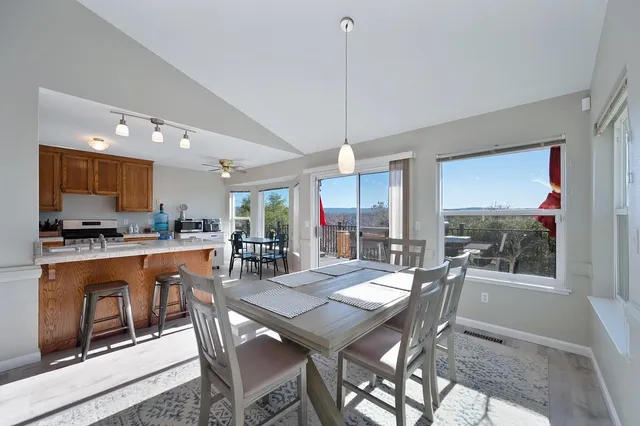 a kitchen with stainless steel appliances granite countertop wooden cabinets a stove top oven a sink and dishwasher